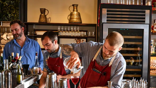Aatxe Restaurant: Three bartenders behind AatxeΓÇÖs brass bar 4